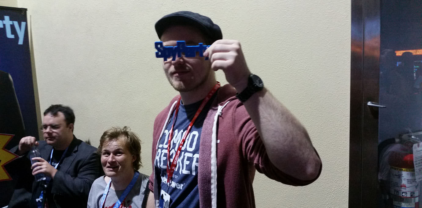 David (canadianbacon) holding a 3D printed version of the game's logo
